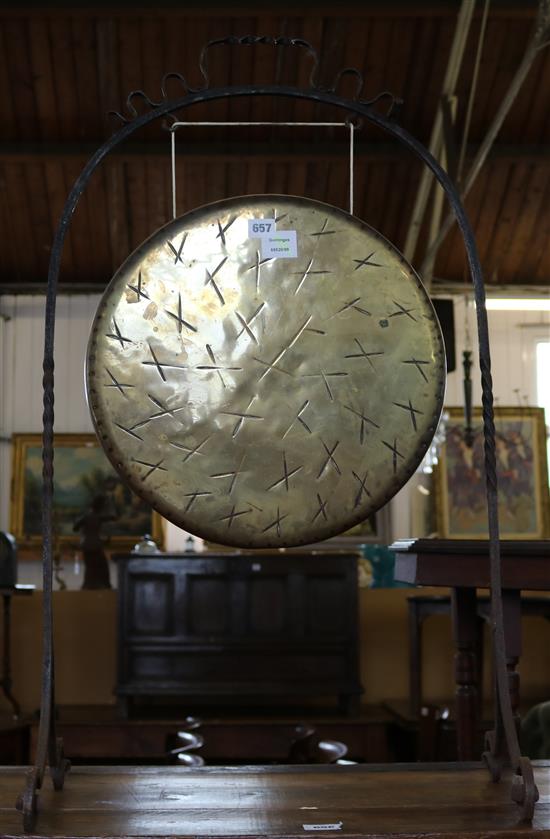 A brass gong in wrought iron frame